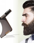 A man with a beard and mustache looking to the side, with a transparent black beard comb in the foreground.